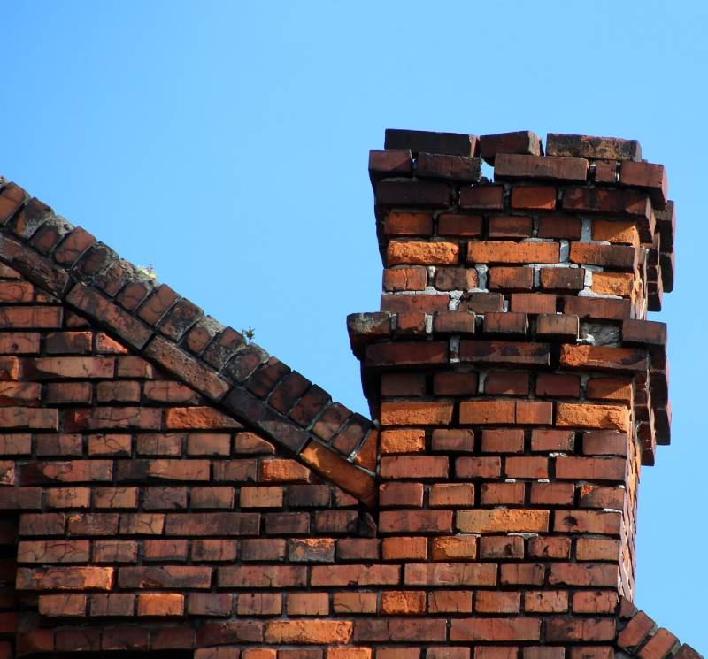 Damaged chimney on an Southfield home showing cracks and missing mortar